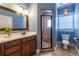 Bathroom featuring blue wall, wooden cabinet vanity, enclosed glass shower, and tiled floors at 2628 White Oak Dr, Decatur, GA 30032