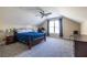 Bedroom features a sloped ceiling, a ceiling fan, and a comfortable bed with blue bedding at 2628 White Oak Dr, Decatur, GA 30032
