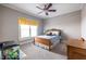 Cozy bedroom featuring a window, carpet, ceiling fan, and dresser with colorful accents at 2628 White Oak Dr, Decatur, GA 30032