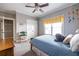 Grey bedroom featuring a window, carpet, ceiling fan, a closet and colorful accents at 2628 White Oak Dr, Decatur, GA 30032