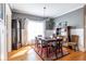 Charming dining room with wood floors, six-seat table, and vintage grandfather clock at 2628 White Oak Dr, Decatur, GA 30032