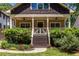 Charming bungalow featuring a cozy front porch, shingled gable, and well-maintained landscaping at 2628 White Oak Dr, Decatur, GA 30032