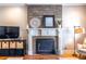 Close up of the fireplace in the living room, highlighted by a custom wood panel at 2628 White Oak Dr, Decatur, GA 30032