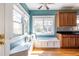 Bright breakfast nook with built-in seating in kitchen featuring stainless appliances and dark countertops at 2628 White Oak Dr, Decatur, GA 30032