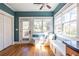Sunlit eat-in kitchen with bench seating, windows, and a door to the backyard at 2628 White Oak Dr, Decatur, GA 30032