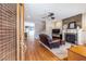 Cozy living room with hardwood floors, a fireplace, and a view into the dining room at 2628 White Oak Dr, Decatur, GA 30032