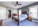Large bedroom with a decorative wood bed frame, ample natural light, and an ensuite bathroom at 2628 White Oak Dr, Decatur, GA 30032