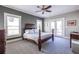 Spacious main bedroom featuring a ceiling fan, plush carpet, and access to an outdoor deck at 2628 White Oak Dr, Decatur, GA 30032
