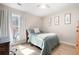 Comfortable bedroom with natural light, desk, and wood-look flooring at 353 Franklin Ln, Acworth, GA 30102