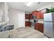 Well-lit kitchen features stainless steel appliances, granite countertops, and dark wood cabinets at 353 Franklin Ln, Acworth, GA 30102