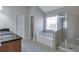 Bathroom featuring a soaking tub and glass shower at 3455 Flycatcher Way, Duluth, GA 30097