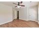 Bedroom showcasing natural light and hardwood floors, complemented by a modern ceiling fan at 3455 Flycatcher Way, Duluth, GA 30097