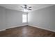 Well-lit bedroom with a modern ceiling fan, neutral walls and beautiful hardwood floors at 3455 Flycatcher Way, Duluth, GA 30097