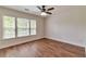 Bright bedroom featuring large windows, hardwood floors, and natural light at 3455 Flycatcher Way, Duluth, GA 30097
