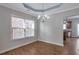 Elegant dining room with hardwood floors, a modern chandelier, and views into the kitchen area at 3455 Flycatcher Way, Duluth, GA 30097