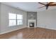 Bright living room features a fireplace with stone accents, hardwood floors, and lots of natural light at 3455 Flycatcher Way, Duluth, GA 30097