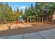 Community playground with slides, swings and mature trees offering natural shade for children at 3455 Flycatcher Way, Duluth, GA 30097