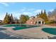 Community pool area with covered seating and a large in-ground pool covered for the off-season at 3455 Flycatcher Way, Duluth, GA 30097