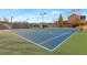 Outdoor community tennis courts with well-maintained surfaces and lighting for evening play at 3455 Flycatcher Way, Duluth, GA 30097