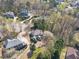 Aerial view of a home with a large backyard, surrounded by mature trees in a quiet neighborhood at 3828 Morning Meadow Ln, Buford, GA 30519