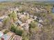 Panoramic aerial shot of a community with beautiful homes nestled among mature trees and landscaping at 3828 Morning Meadow Ln, Buford, GA 30519