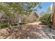 Cozy backyard featuring a fire pit and seating area, surrounded by mature trees and landscaping at 3828 Morning Meadow Ln, Buford, GA 30519
