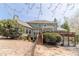 Landscaped backyard with a wooden deck and stairs leading to the home's entrance at 3828 Morning Meadow Ln, Buford, GA 30519
