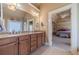 Bathroom featuring double sinks, and a view into the adjacent bedroom at 3828 Morning Meadow Ln, Buford, GA 30519