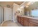 Bathroom featuring dual sinks, granite countertops, and modern fixtures at 3828 Morning Meadow Ln, Buford, GA 30519