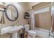 Cozy bathroom featuring a pedestal sink, tiled walls, and a shower-tub combination at 3828 Morning Meadow Ln, Buford, GA 30519