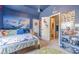 Stylish bedroom featuring a blue accent wall and comfortable furnishings at 3828 Morning Meadow Ln, Buford, GA 30519