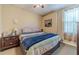 Bedroom with plush bed, side tables, and window view, offering a cozy retreat at 3828 Morning Meadow Ln, Buford, GA 30519