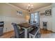 Charming dining room with wainscoting, a rustic wood table, and stylish decor at 3828 Morning Meadow Ln, Buford, GA 30519