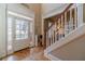 Welcoming foyer featuring hardwood floors, a staircase, and a bright entryway leading into the home at 3828 Morning Meadow Ln, Buford, GA 30519