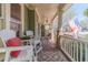 Spacious front porch with comfortable seating, decorative rugs, and classic architectural details at 3828 Morning Meadow Ln, Buford, GA 30519