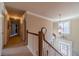 Upstairs hallway with overhead chandelier and beautiful staircase at 3828 Morning Meadow Ln, Buford, GA 30519
