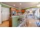 Modern kitchen with a breakfast bar, stainless steel appliances, and hardwood floors at 3828 Morning Meadow Ln, Buford, GA 30519