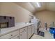 Well-equipped laundry room with ample counter space and modern appliances at 3828 Morning Meadow Ln, Buford, GA 30519