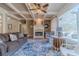 Inviting living room with a fireplace, coffered ceiling, large windows, and stylish decor at 3828 Morning Meadow Ln, Buford, GA 30519