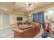 Comfortable living room with a leather sofa, entertainment center, and a ceiling fan at 3828 Morning Meadow Ln, Buford, GA 30519