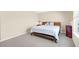 Comfortable bedroom features a wooden bed frame and a window with natural light at 5034 Little Harbor Way, Acworth, GA 30101