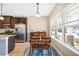 Dining area with wood table set, chairs, and light fixture by window and view to front yard at 5034 Little Harbor Way, Acworth, GA 30101