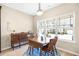 Dining area with wood table set, chairs, and view to front yard through large window at 5034 Little Harbor Way, Acworth, GA 30101