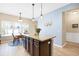 Kitchen island with granite counters, dark cabinets, and breakfast nook at 5034 Little Harbor Way, Acworth, GA 30101