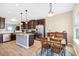 Kitchen boasts stainless steel appliances, wood cabinets and trim, and island with granite countertop at 5034 Little Harbor Way, Acworth, GA 30101