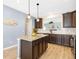 Kitchen with granite counters, island with dark cabinets, stainless appliances and open access to Gathering room at 5034 Little Harbor Way, Acworth, GA 30101