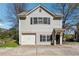 Exterior view of a two-story home with a garage and a well-maintained yard at 1433 Carroll Drive Nw, Unit #3, Atlanta, GA 30318