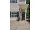 Close-up of the entrance with a cozy porch, dark door, and neat landscaping at 1433 Carroll Drive Nw, Unit #3, Atlanta, GA 30318