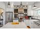 Bright kitchen with stainless steel appliances, granite countertops, and rustic wood backsplash at 1433 Carroll Drive Nw, Unit #3, Atlanta, GA 30318