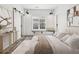 Modern main bedroom with shiplap walls, decorative lighting, and a bench by the window at 1433 Carroll Drive Nw, Unit #3, Atlanta, GA 30318